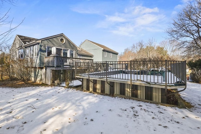 snow covered property with a deck