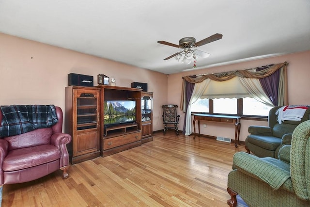 living room featuring hardwood / wood-style flooring and ceiling fan