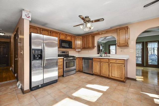 kitchen with ceiling fan, stainless steel appliances, sink, and light tile patterned floors