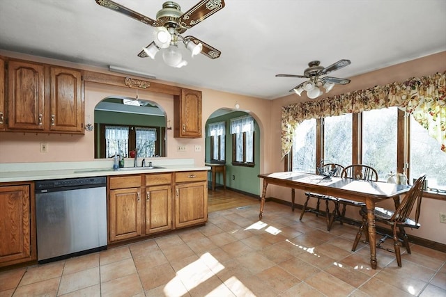 kitchen with sink, stainless steel dishwasher, ceiling fan, and light tile patterned floors