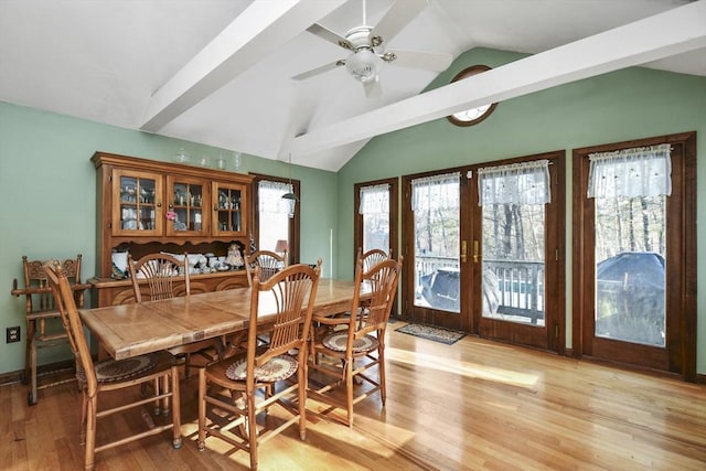 dining space with french doors, a healthy amount of sunlight, and vaulted ceiling