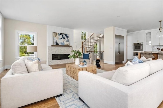34 Otis Hill Rd, Hingham, MA 02043 - living area with light wood-style floors, plenty of natural light, a fireplace, and baseboards