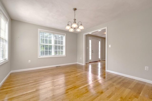 2 Dalton Ter, Holbrook, MA 02343 - empty room featuring a chandelier, plenty of natural light, and light wood-style floors