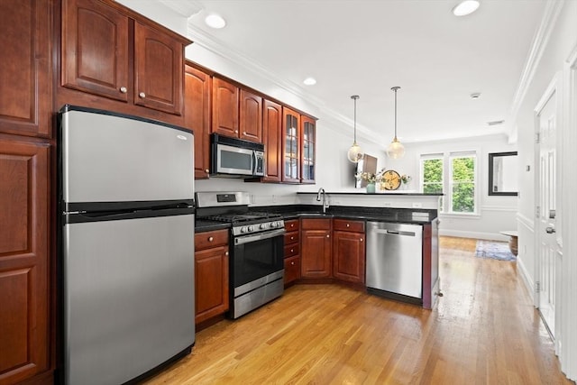 53 Woodward St Unit 2, Boston, MA 02127 - kitchen featuring stainless steel appliances, a peninsula, light wood-type flooring, ornamental molding, and glass insert cabinets
