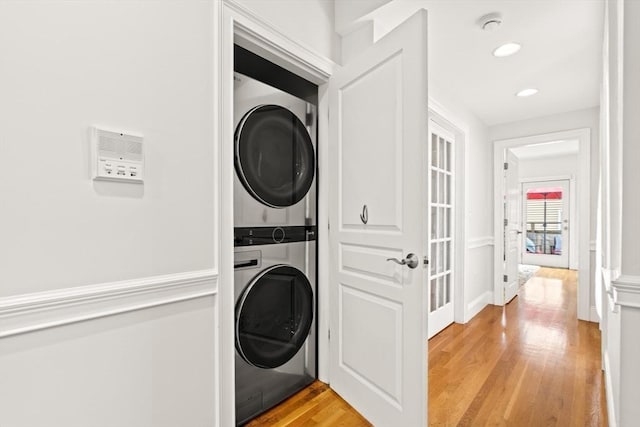 53 Woodward St Unit 2, Boston, MA 02127 - laundry area with estacked washer and dryer, light wood-type flooring, recessed lighting, and baseboards
