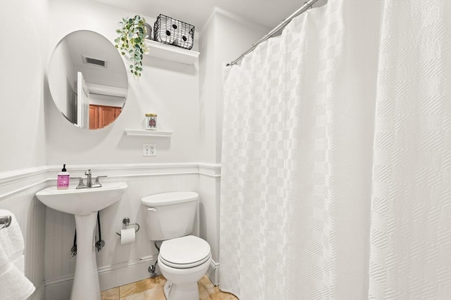 53 Woodward St Unit 2, Boston, MA 02127 - full bathroom with toilet, tile patterned floors, wainscoting, and a shower with shower curtain
