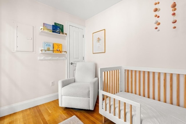 53 Woodward St Unit 2, Boston, MA 02127 - bedroom with wood finished floors, baseboards, and electric panel