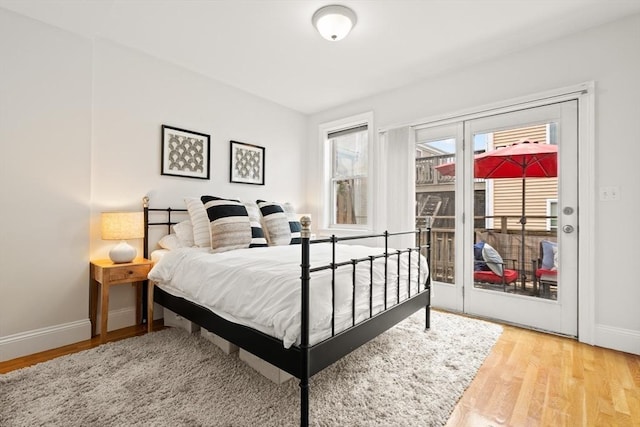 53 Woodward St Unit 2, Boston, MA 02127 - bedroom featuring access to exterior, wood finished floors, and baseboards