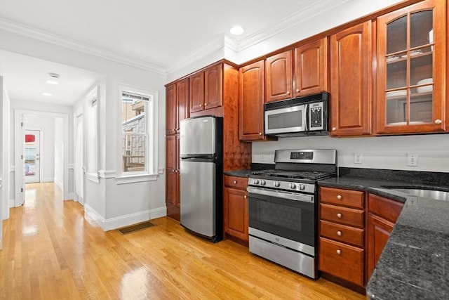 53 Woodward St Unit 2, Boston, MA 02127 - kitchen with stainless steel appliances, light wood finished floors, baseboards, glass insert cabinets, and dark stone counters