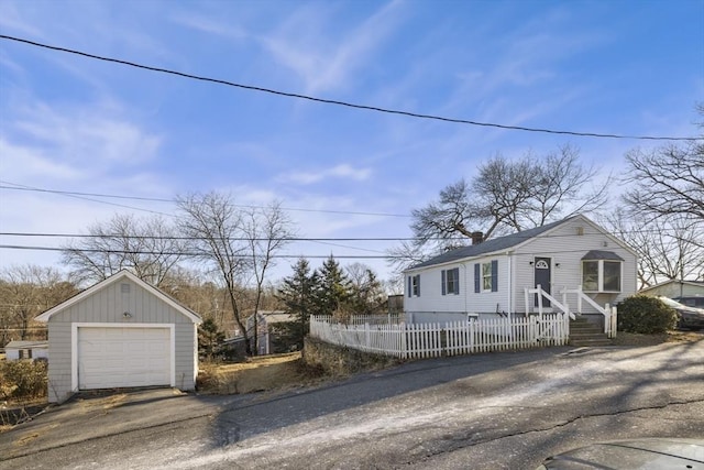 view of front of house featuring a garage and an outdoor structure