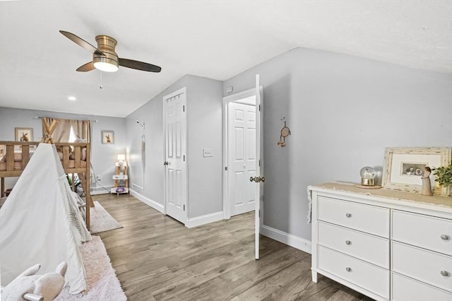 bedroom featuring vaulted ceiling, a ceiling fan, light wood-style flooring, and baseboards