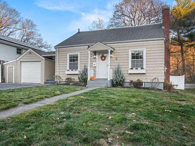 bungalow-style house with roof with shingles, a chimney, a front yard, fence, and a garage