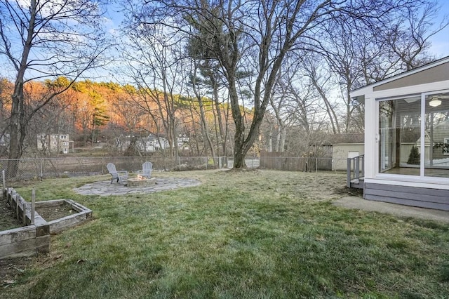 view of yard with a patio area, a fenced backyard, and a fire pit