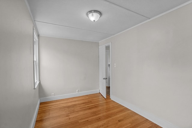 empty room featuring ornamental molding and light hardwood / wood-style floors