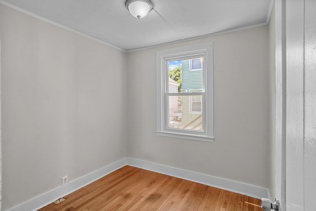 spare room with crown molding and hardwood / wood-style flooring