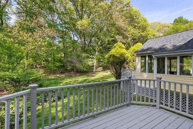 wooden terrace with a lawn