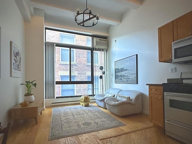 doorway featuring beamed ceiling, light hardwood / wood-style floors, and an inviting chandelier