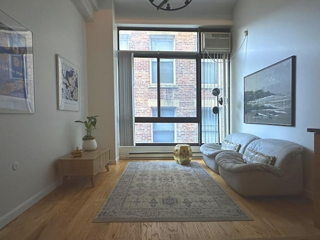 interior space featuring a wall unit AC and light hardwood / wood-style floors