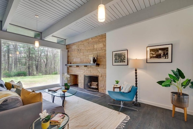 living area with wood finished floors, a fireplace, beamed ceiling, baseboards, and wooden ceiling