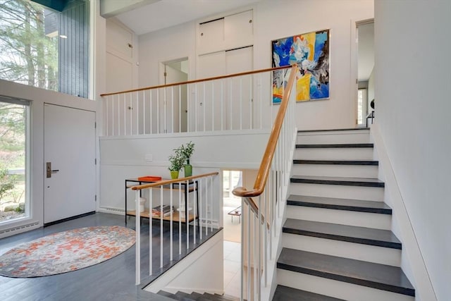 foyer entrance with stairs and wood finished floors