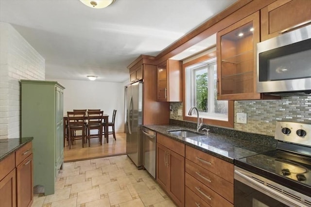 15 Temi Rd, Beverly, MA 01915 - kitchen featuring stainless steel appliances, a sink, brown cabinets, tasteful backsplash, and glass insert cabinets
