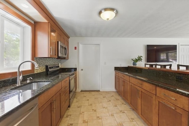 15 Temi Rd, Beverly, MA 01915 - kitchen with stainless steel appliances, a sink, and brown cabinets