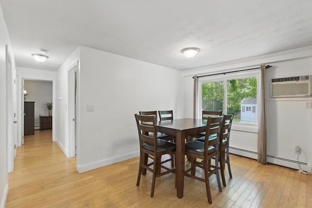 15 Temi Rd, Beverly, MA 01915 - dining room featuring light wood-type flooring, a wall unit AC, a baseboard radiator, and baseboards