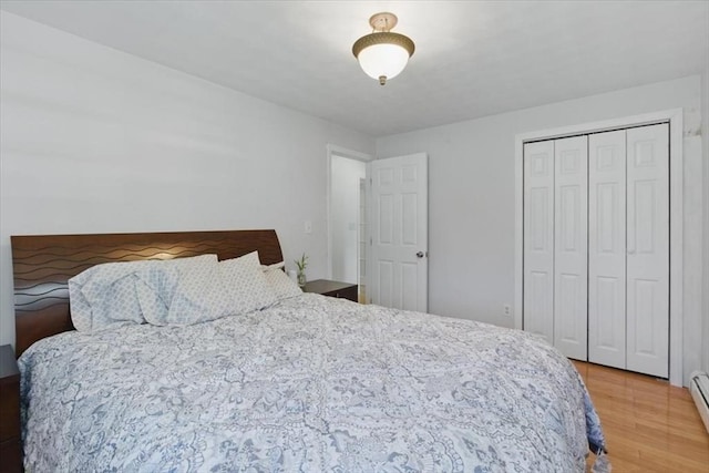 15 Temi Rd, Beverly, MA 01915 - bedroom featuring wood finished floors, a baseboard heating unit, and a closet