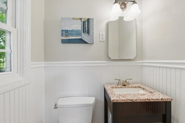 15 Temi Rd, Beverly, MA 01915 - bathroom featuring a wainscoted wall, vanity, healthy amount of natural light, toilet, and a decorative wall