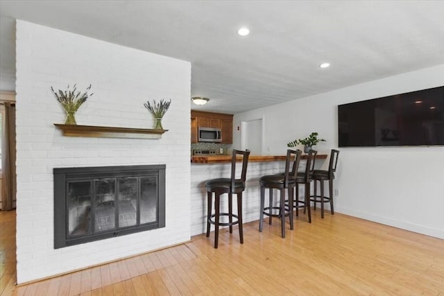 15 Temi Rd, Beverly, MA 01915 - living area with wood finished floors, baseboards, a fireplace, and recessed lighting