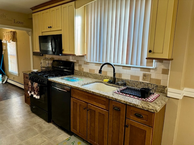 kitchen with sink, baseboard heating, backsplash, black appliances, and light stone countertops