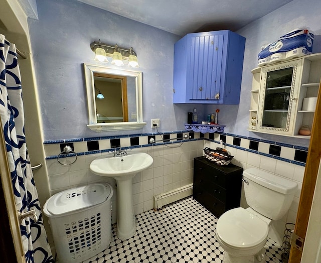 bathroom featuring decorative backsplash, a baseboard heating unit, tile walls, and toilet