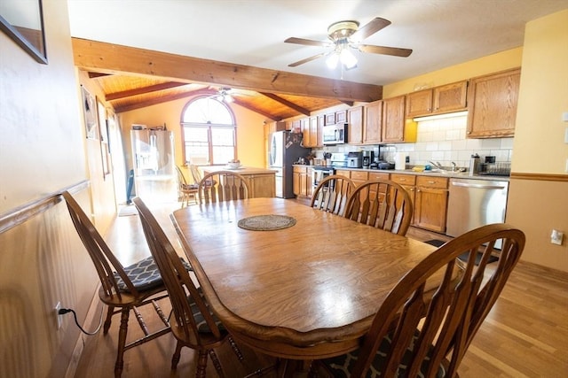 dining space with lofted ceiling with beams, sink, wood ceiling, ceiling fan, and light hardwood / wood-style flooring