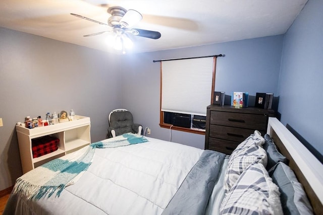 bedroom featuring cooling unit and ceiling fan