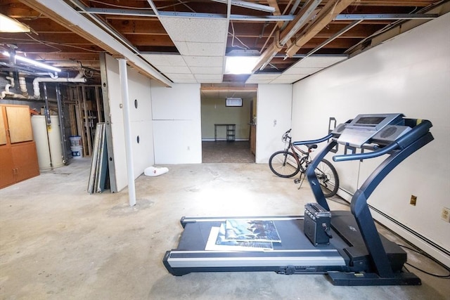 exercise area featuring gas water heater and a paneled ceiling