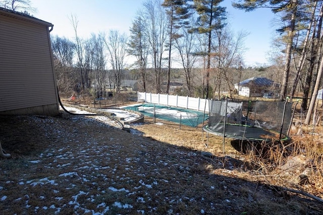 view of swimming pool with a trampoline