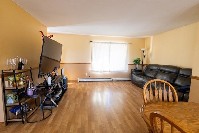 living room featuring baseboard heating and hardwood / wood-style floors