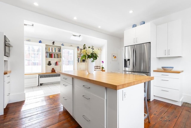 kitchen featuring dark wood-style flooring, radiator, wooden counters, and stainless steel fridge with ice dispenser