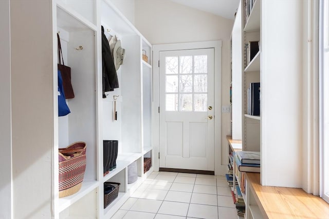 mudroom featuring vaulted ceiling and light tile patterned flooring