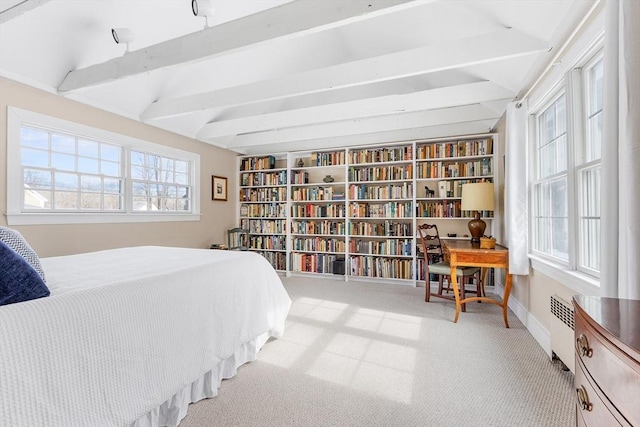 bedroom with carpet floors, radiator, lofted ceiling with beams, and baseboards