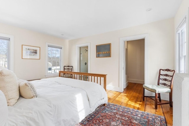 bedroom featuring light wood-style flooring and baseboards