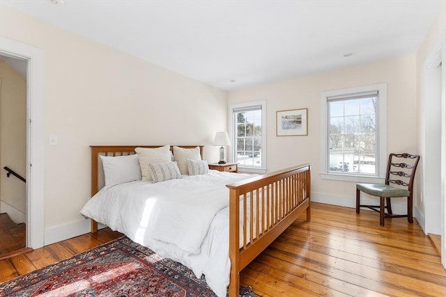 bedroom with light wood-style flooring and baseboards