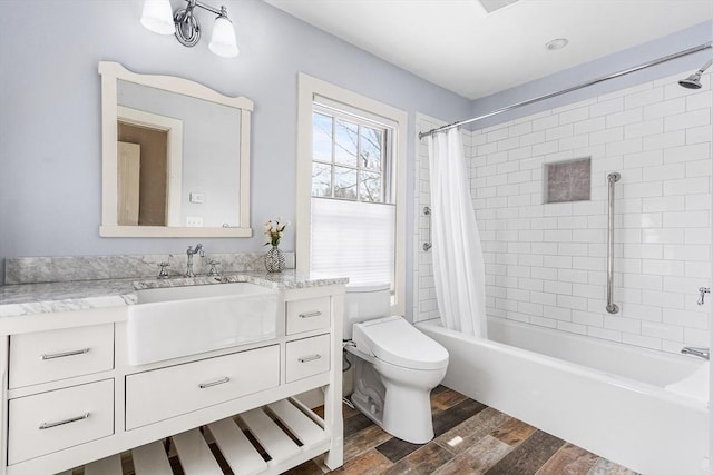 bathroom featuring shower / tub combo, vanity, toilet, and wood finished floors