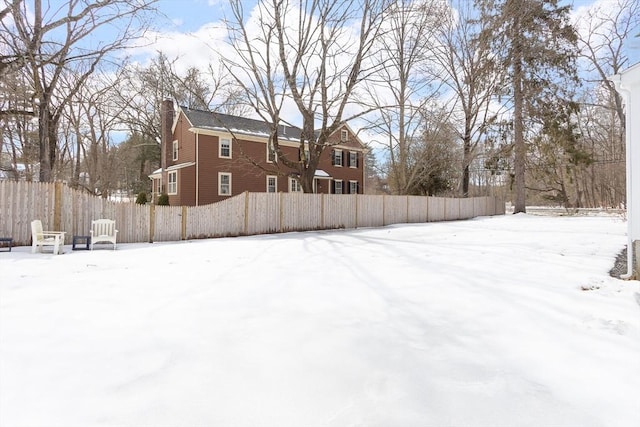 snowy yard with fence