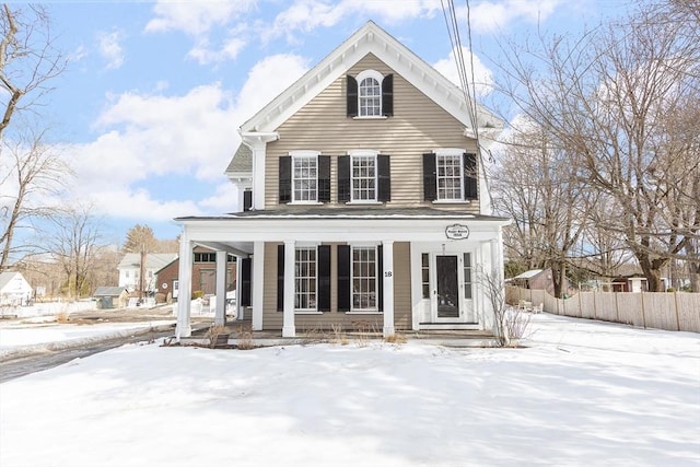 view of front of property featuring a porch and fence