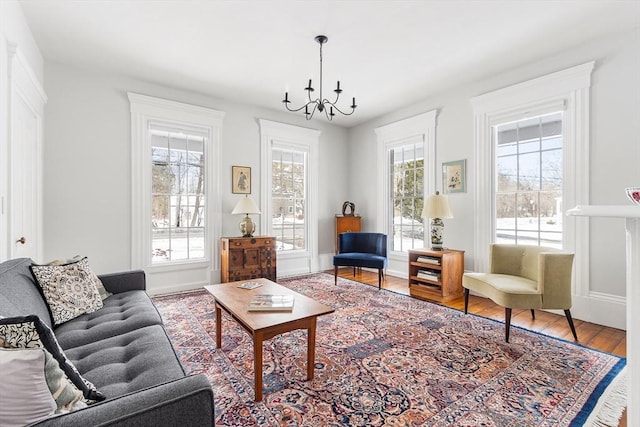 living area with a chandelier and wood finished floors