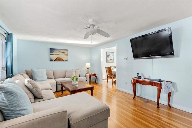 living room featuring light hardwood / wood-style floors and ceiling fan