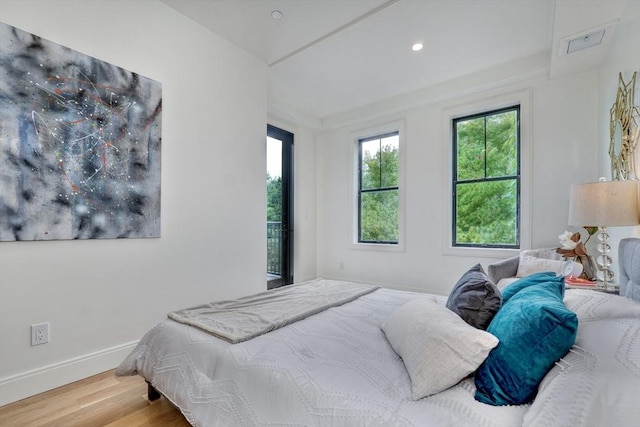 bedroom with recessed lighting, baseboards, and wood finished floors