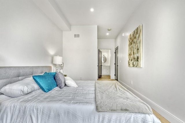 bedroom featuring visible vents, recessed lighting, ensuite bath, and baseboards