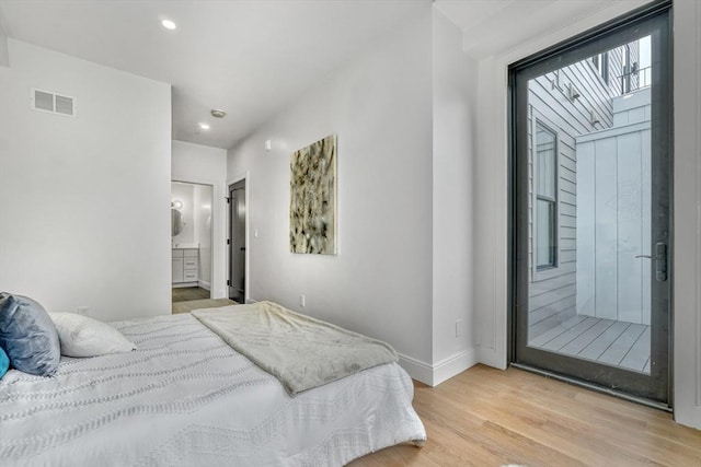 bedroom featuring visible vents, ensuite bath, wood finished floors, recessed lighting, and baseboards